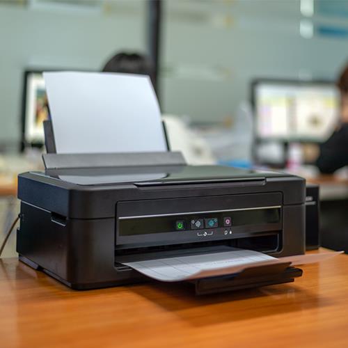A Printer Sitting on a Desk in an Office, Showcasing How Personal Checks Online Printing Is Made Easy and Affordable
