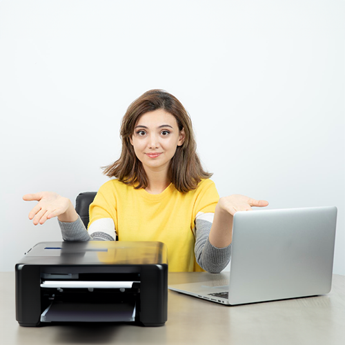 A Young Woman with a Printer in Front of Her Laptop, Exploring Options to Write Check Online Free for Convenient Financial Transactions. She Prints Her Checks at the End.