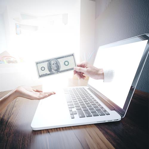 A Woman Handing a Dollar Bill to a Man in Front of a Laptop, Symbolizing an Get Paid Early