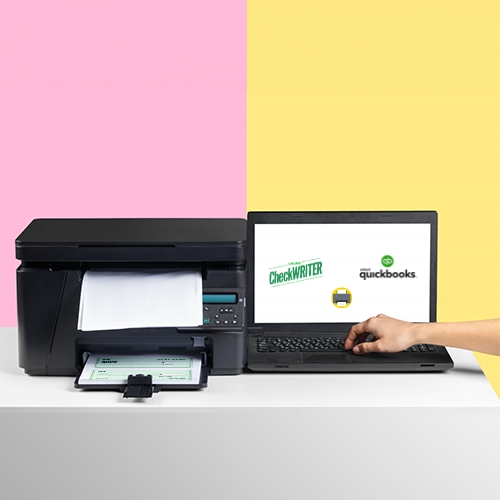 A Hand Holding a Printer and a Laptop, with the Screen Showing QuickBooks Online Software