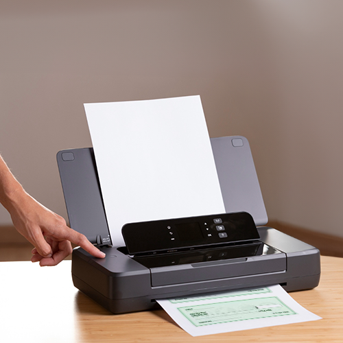 A Person Is Using a Printer for Printing Checks for Business
