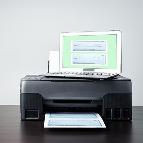 A Printer with a Laptop Placed on Top of It, Symbolizing the Innovative Feature of Printing Checks For Free