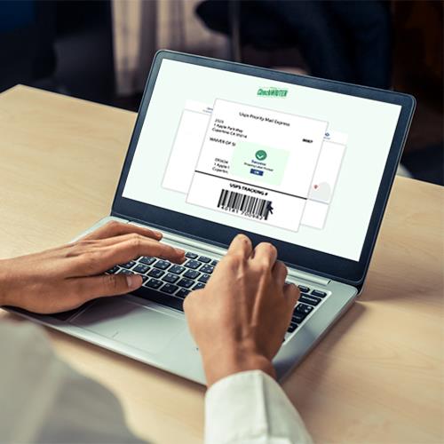 A Person Using a Laptop to Create a Shipping Label, Visible by the Barcode Displayed on the Screen.