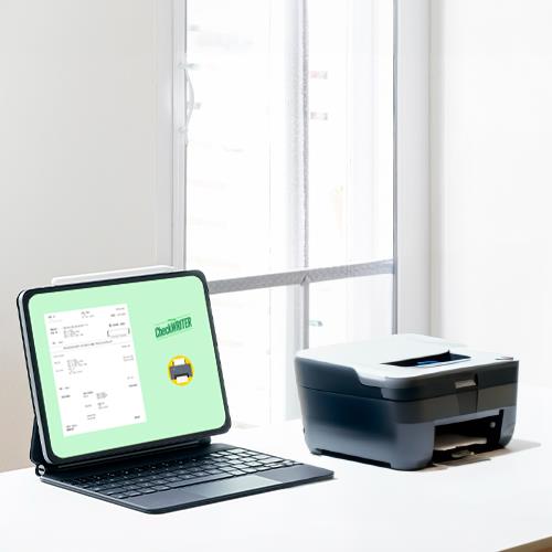 A Laptop, Printer, and Tablet Sit on a Desk, Showcasing Software For Printing Checks
