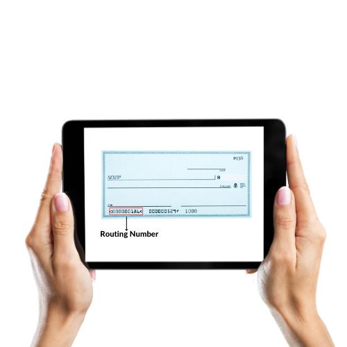 Hands Holding a Tablet Displaying a Check with Routing Numbers for the Purpose of Check Routing Number Location