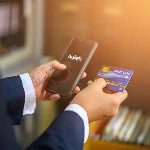 A Person Holding a Smartphone and the Best Business Credit Card