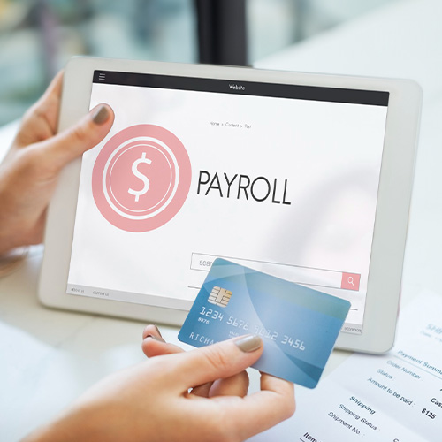 A Person Using a Credit Card for Paying Payroll With Credit Card Via a Tablet Showing a Payroll Services page