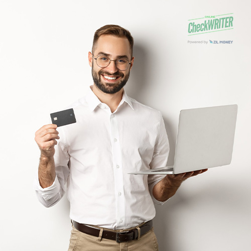 A Smiling Man Holding a Laptop in One Hand and Manage Card Efficiently and Easly in the Other, Standing Against a Plain White Background
