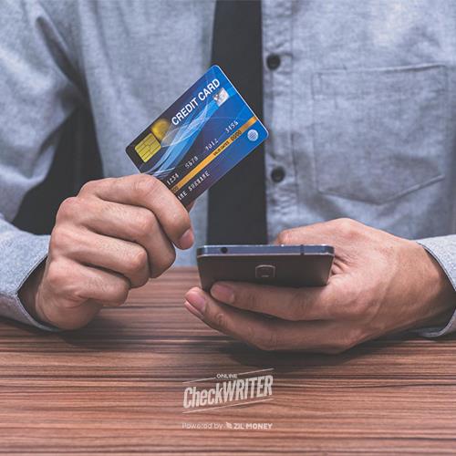 A Professional Using a Credit Card and Smartphone for an Online Transaction, Serving as a Melio Payments Alternative