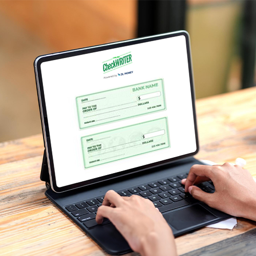 A Man Typing on a Laptop. He Is Using an Online Paycheck Stub to Manage Finances