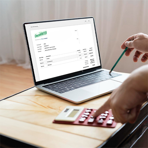 A Person Using a Laptop Displaying Check Writing Software, Simplifying Receivables with the Best Invoice Software.