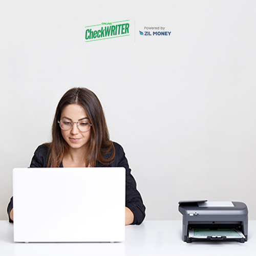 Laptop and Printer on the Table. A Woman Sitting on a Chair Working on Her Laptop. She Is Printing Checks Instead of Walmart Checks Online