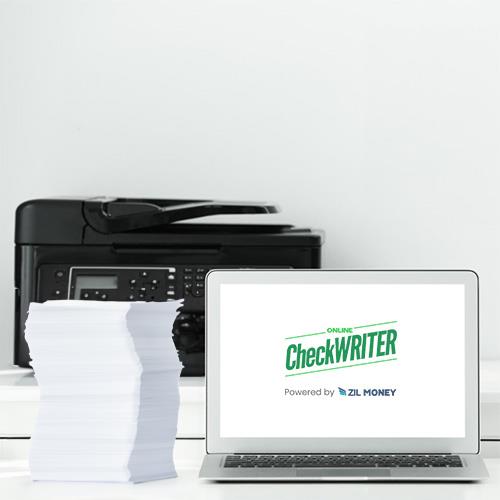 There's a Laptop, Printer and Paper Bundle on the Table. Presently Print Checks on Blank Check Online