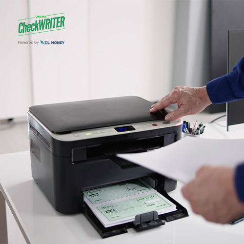 The Printer Is on the Table. A Man Using Check Printing Software For Print Checks