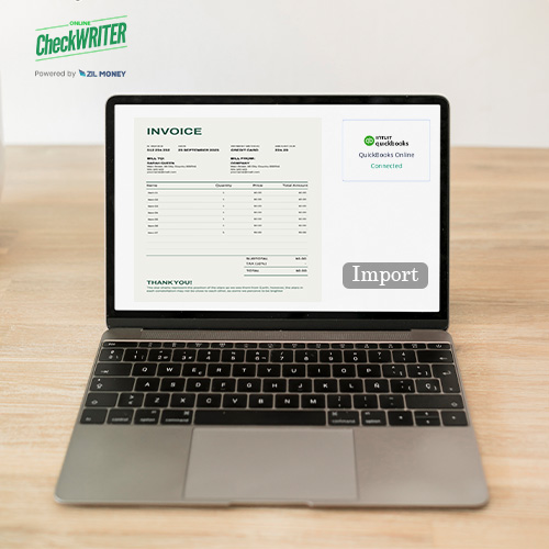 A Laptop Open on a Table, with a Screen Displaying a Free QuickBooks Invoice Interface