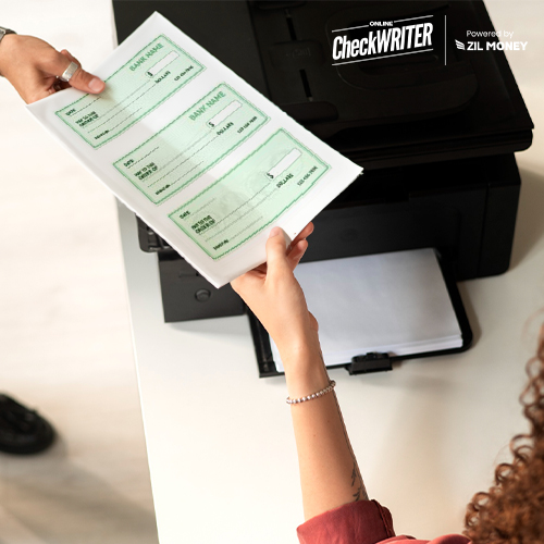 A Person Standing Next To a Regular Printer Holding Checks. Simplify Your Finances with Free Printable Checks Online