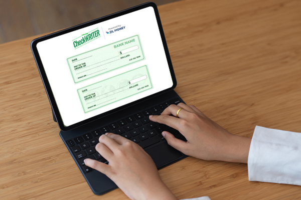 A Person woring On a Laptop Designing Checks, Checks Design, Printing, & Mailing Make Vendor Payments Easy