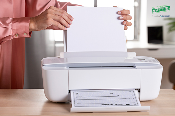 The Printer Is on the Table. A Person Writing Check Online Free And Printing