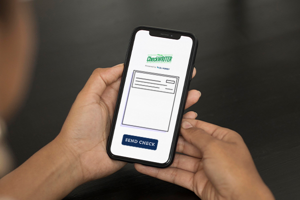 A Person Using a Smartpone To Receive Checks, How To Receive Checks and How to Send Them Effectively