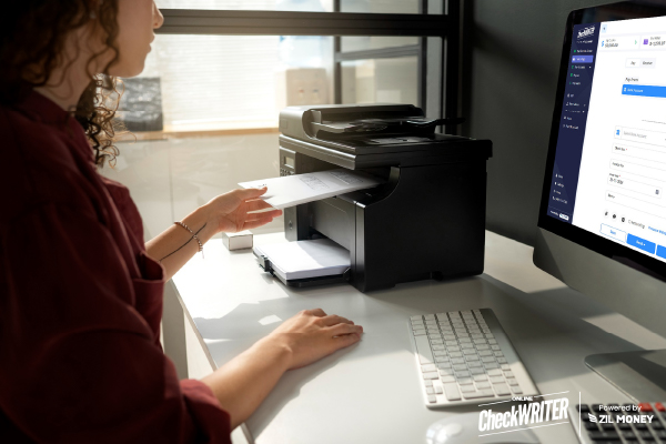 A Woman Printing Checks Using A Regular Printer And Blank Paper. Instant Checks Printing Solutions Instead of Pre-Printed Checks