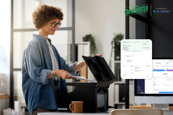 A Woman Printing Payroll Checks Using A Regular Printer. Instant Checks Printing Solutions Instead of Pre-Printed Checks