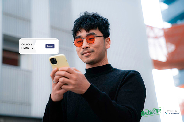A Man Using A Smartphone To Make Payments. Represents NetSuite Integration, The Smartest Move for Business Payments
