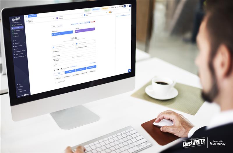 Deluxe Checks Alternative Displayed on a Computer Screen as a Man Creates and Prints Checks Using an Online Check Writing Platform at His Desk.