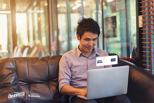 Netsuite Integration Displayed on a Laptop Screen as a Young Man Works on His Computer in a Modern Office Setting, Showcasing Efficiency and Technology.