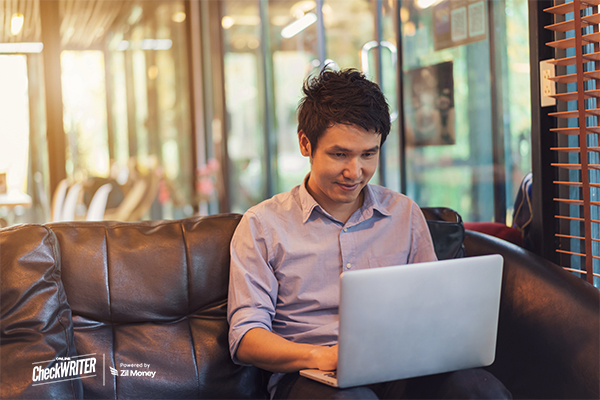 Netsuite Integration shown as a young professional works on a laptop in a modern office setting, symbolizing seamless business management and productivity.