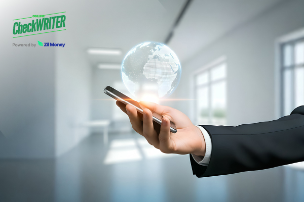 A Man Holding A Smartphone To Make an International Payment. Send Wire Transfers, ACH, and eChecks Instantly to Prevent Delays