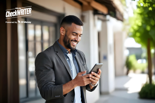NetSuite Integration Shown in Action as a Smiling Businessman Uses a Mobile Phone Outdoors, Representing Seamless Bill Syncing and Payments on the Go.