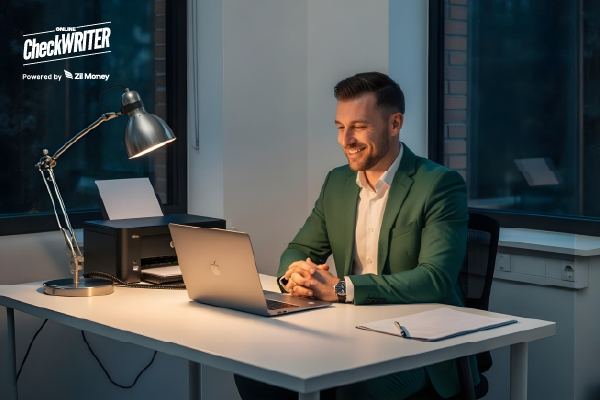 A Man Using A Laptop to Make a Payment. Manage Your Finances with a Digital Check Register.