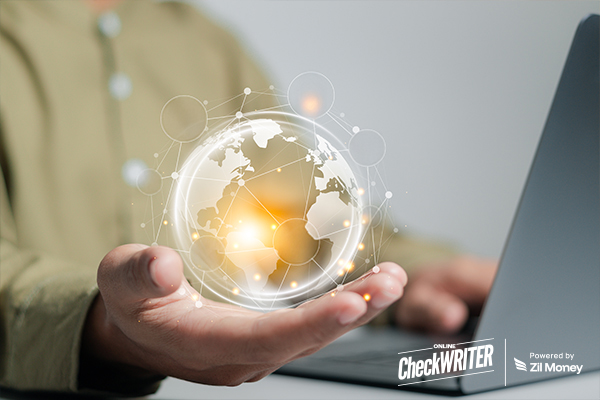 A person holds a glowing digital globe while using a laptop, symbolizing the global reach and convenience of international payments.