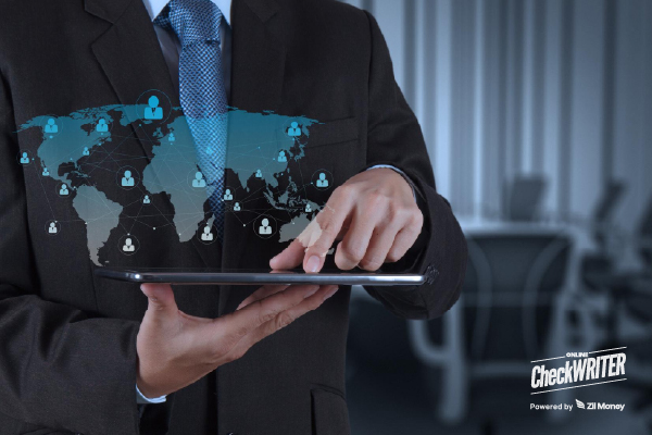 A Businessman Using a Tablet with a Global Network Overlay, Showing the Speed and Reach of International Payments.