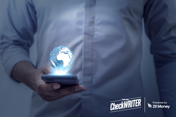 A Person Holds a Smartphone with a Glowing Digital Globe Above It, Symbolizing International Payments and Fast Global Money Transfers.