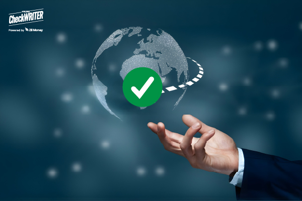 A business hand holding a digital globe with a check mark, symbolizing secure international payment solution.
