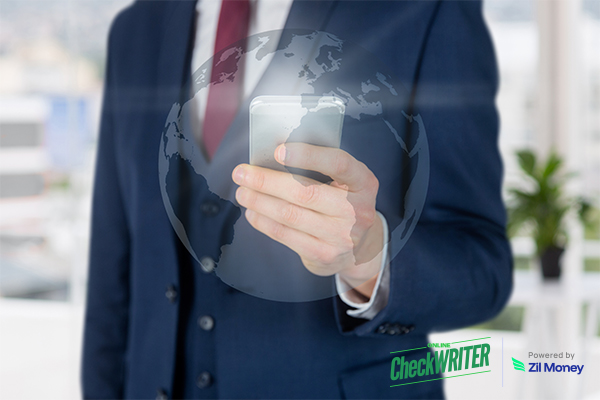 Businessman Using Smartphone with Globe Overlay, Showing the Speed and Ease of International Payments.