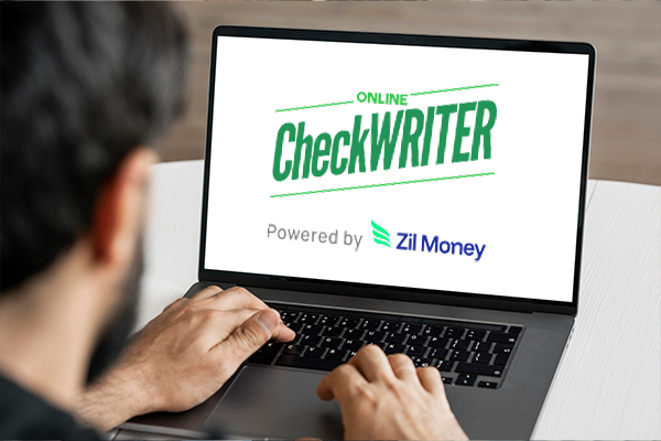Man using a laptop with Online CheckWriter, a modern Walmart Checks alternative for faster and secure printing.