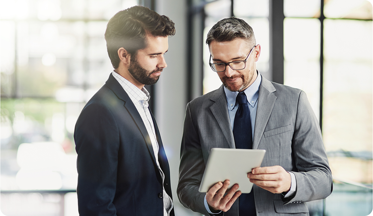 Two Businessmen Discussing the Usage of a Virtual Card, That Represents an Excel Bulk Card, Streamline Virtual Card Creation in Minutes