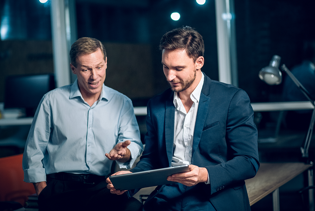 An Image That Shows Two Persons Using A Tablet to Make Virtual Cards to Make Payments. Manage Team Spending with a Team Expense Management Card