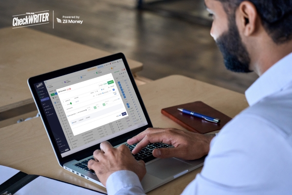 Man on a laptop using an online payment dashboard to set up Check Mailing, showing modern, secure payment processing.