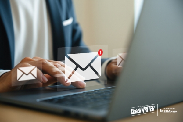 Close-up of a person typing on a laptop, with digital mail icons floating above, signifying fast, digital Check Mailing.