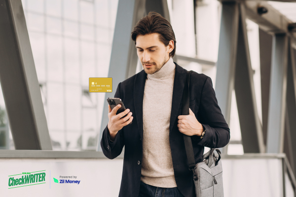 Man in a suit viewing a tablet that displays a digital, globe-adorned Los Angeles Virtual Card for secure global payments.