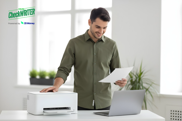 How On-Demand Check Printing Supports Daily Business Needs: Save 80% with Blank Stock Paper A Man Using A Printer and a Laptop to Print a Check Easily. Cheap Checks Save 80% with On-Demand Printing