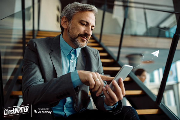 One Platform, Zero Printing: The New Standard for Check Mailing Efficiency A business professional using a smartphone to send a Check Mailing request.