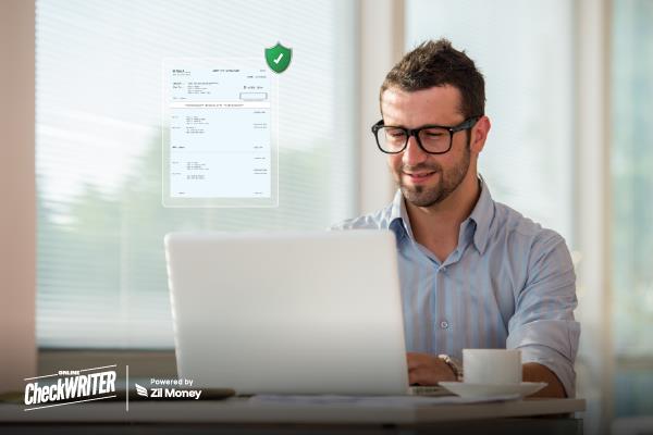 7 Reasons Positive Pay Is the Easiest Way to Stop Check Fraud in 2025 A man working on a laptop with a secure check verification icon displayed beside him, representing Positive Pay fraud protection
