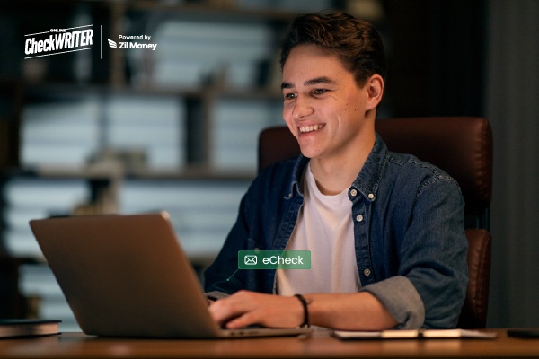 The New Standard for Remote-Friendly Payments: Send eChecks from Anywhere A Person Smiling While Sending an Echeck on a Laptop, Representing Fast and Remote-Friendly Digital Check Payments.