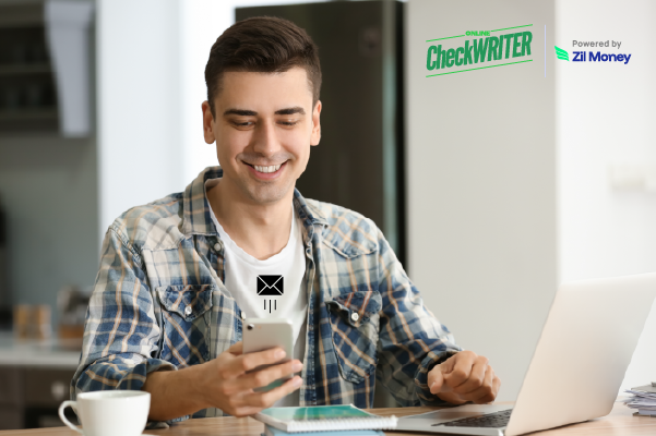 7 Reasons eChecks & Customizable Checks Are Transforming Payments in 2025 Person Smiling While Receiving an eChecks Notification on Their Phone, with a Laptop Nearby