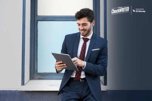 4 Smart Ways to Receive Checks and Speed Up Cash Flow in 2026 Business professional using tablet to receive checks digitally with secure, fast payment access.