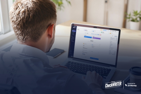 How Offering Same Day ACH Payments Improves Your Customer Relationships Business owner using laptop to process Same Day ACH payments for faster and secure transactions.